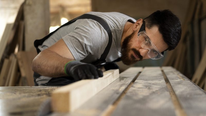 carpenter-cutting-mdf-board-inside-workshop
